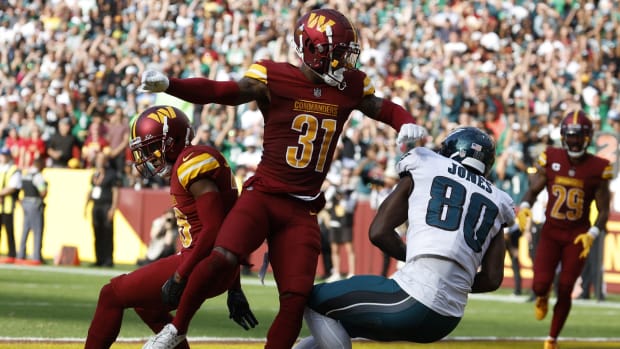 Oct 29, 2023; Landover, Maryland, USA; Philadelphia Eagles wide receiver Julio Jones (80) catches a touchdown pass as Washington Commanders safety Kamren Curl (31) defends during the fourth quarter at FedExField.